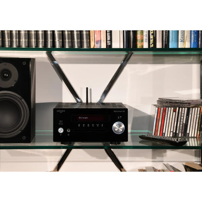 Advance Paris MyConnect 60 All-in-One schwarz Lifestyle im Regal mit Lautsprechern