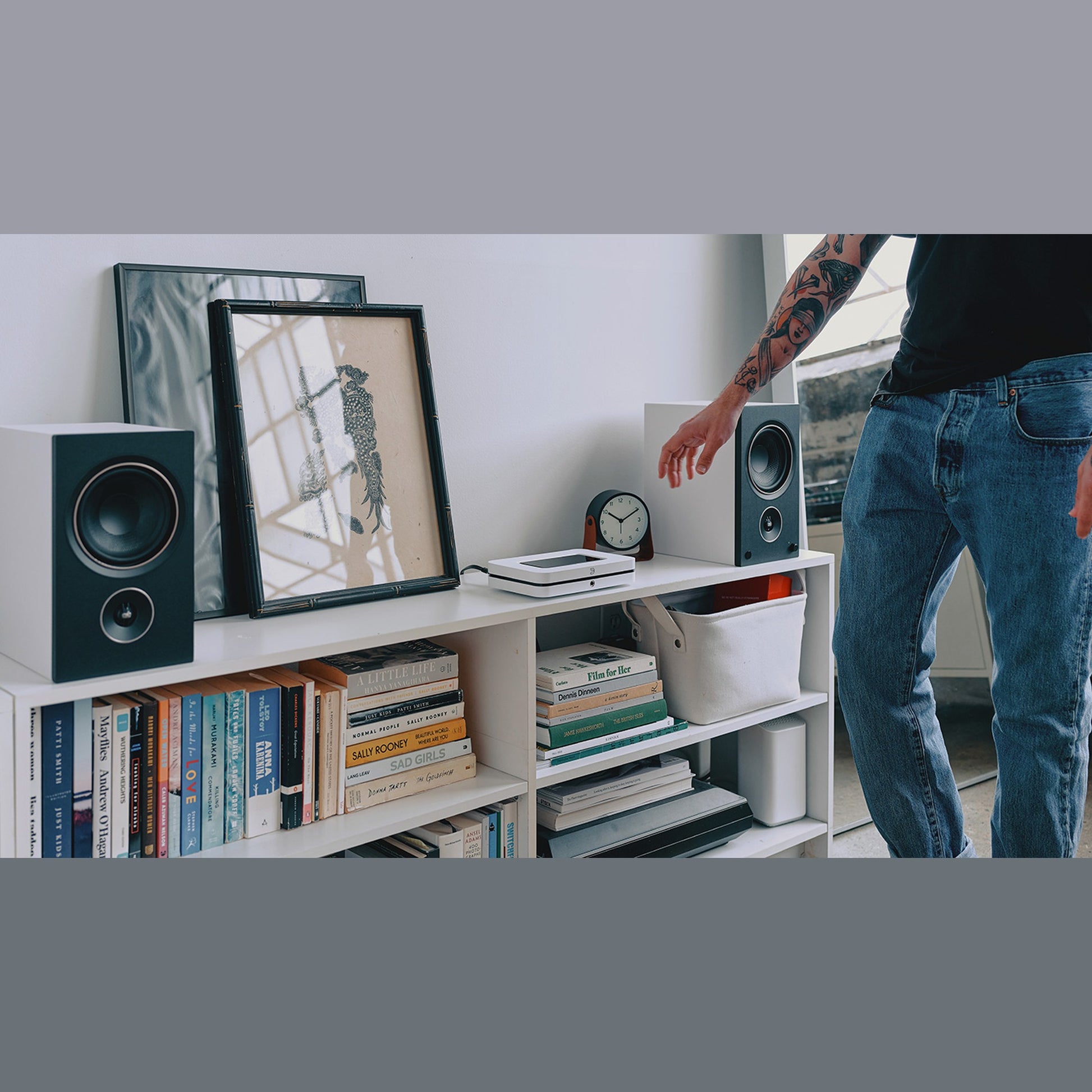 Bluesound Node Netzwerk-Streamer Weiss Lifestyle im Bücherregal zwischen zwei Regallautsprechern