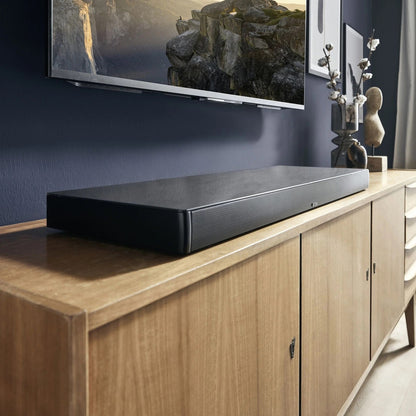 Canton Smart Sounddeck 100 S2 Sounddeck Schwarz Lifestyle auf Sideboard unter wandmontiertem TV