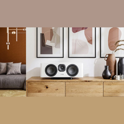 Canton Vento 51 Center-Lautsprecher Weiss Lifestyle auf Sideboard vor einer Bilderwand