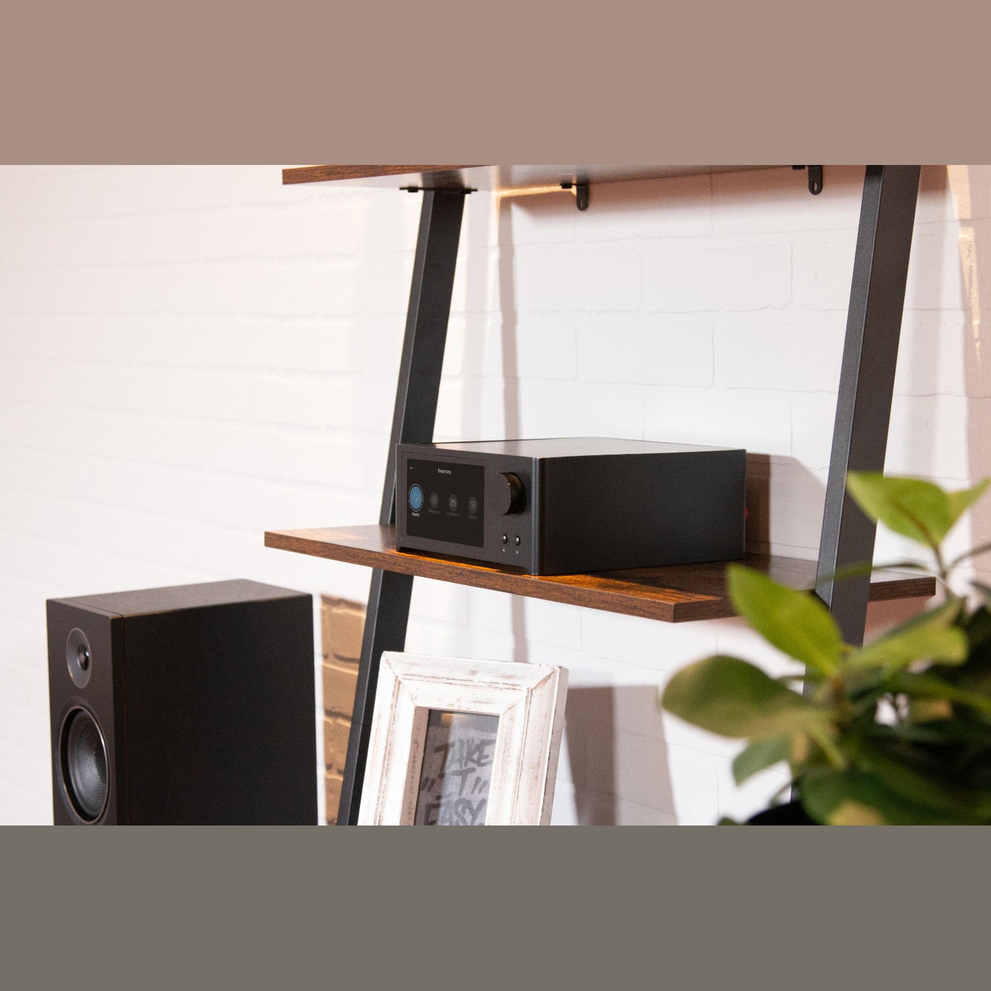 NAD C700 V2 BluOS Streaming-Vollverstärker Lifestyle auf Wandregal im Wohnzimmer