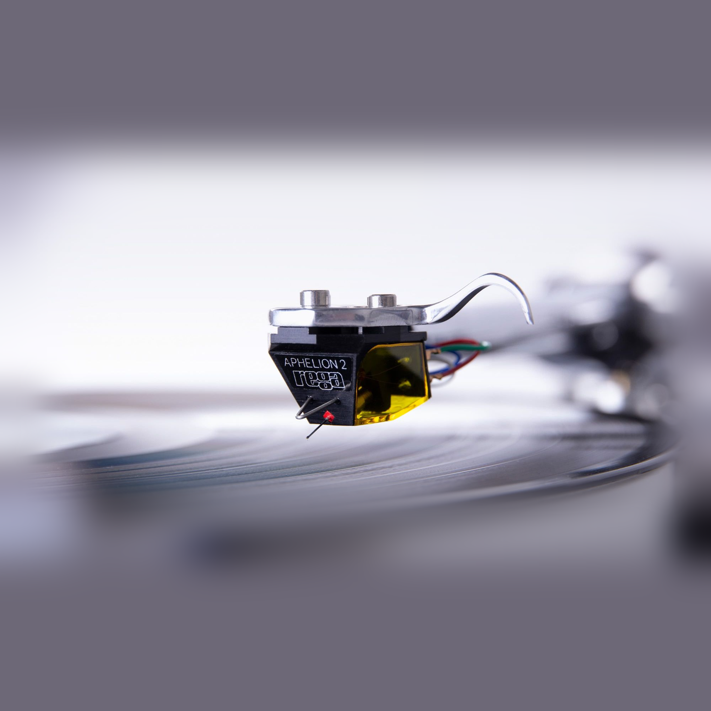 Rega Aphelion 2 MC-Tonabnehmer Nahaufnahme montiert auf Tonarm über der Schallplatte