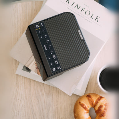 Sangean DCR-90BT DAB+ Radiowecker, Black, Lifestyle Draufsicht auf Zeitschrift