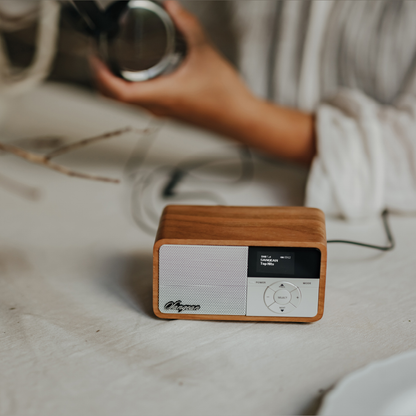 Sangean DDR-7X DAB+ Holzradio mit Akku Lifestyle auf Tisch neben Kopfhörer in Light Wood