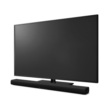 Yamaha True X Bar 40A Dolby-Atmos-Soundbar Schrägansicht vor einem Fernseher auf dem Sideboard